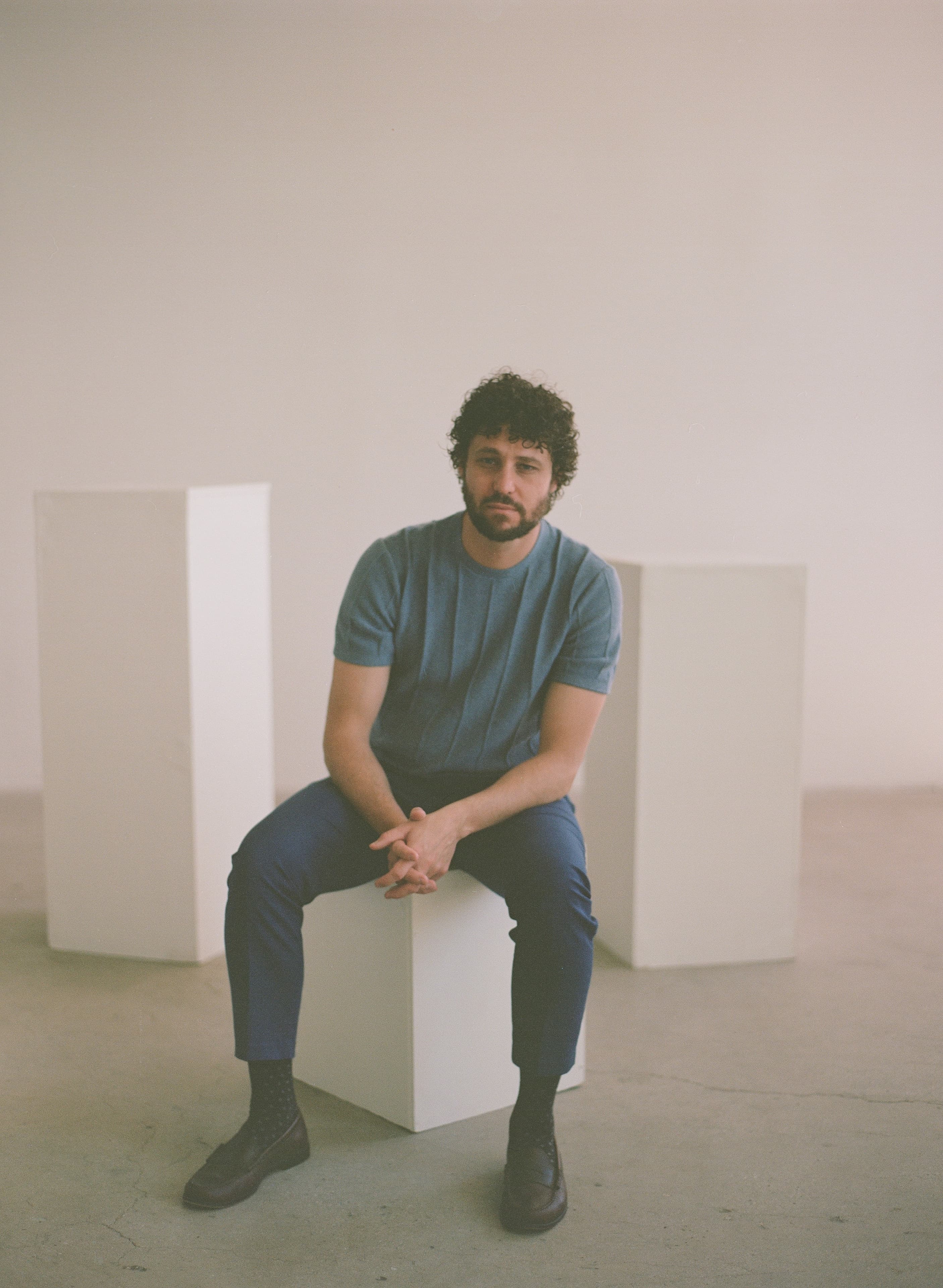 Editorial film portrait of Dr. James Manning seated in a minimal studio.